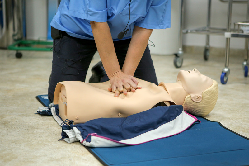 Instructor demonstrating CPR on a training manikin